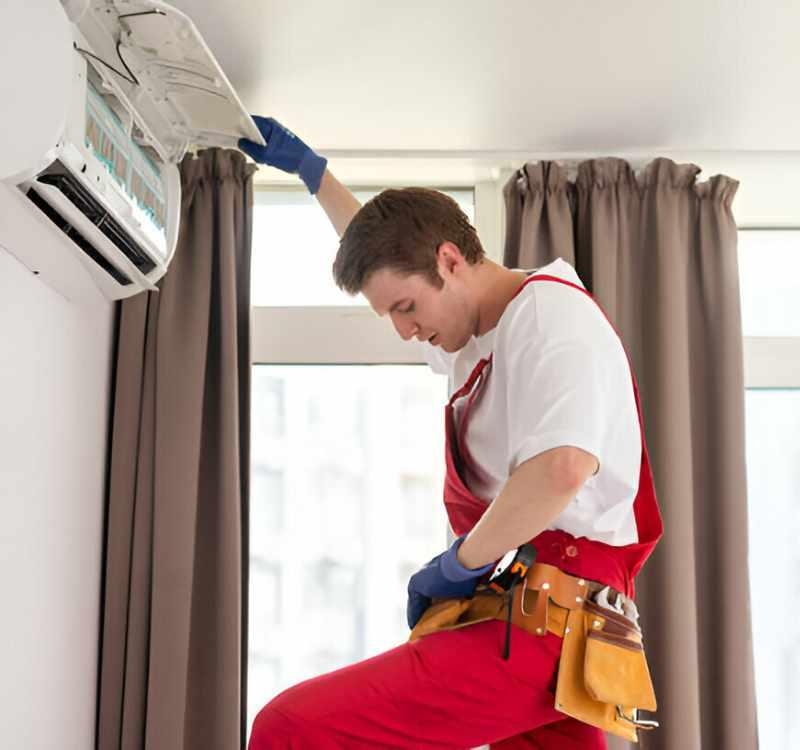 HVAC technician servicing unit